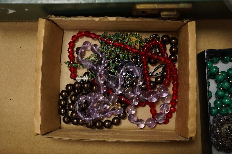 A quantity of assorted costume and and other jewellery including amethyst beads, malachite beads, tiger's eye quartz pendant, unmounted shell cameos, etc. Condition - poor to fair to good